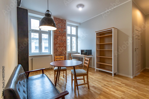 Fully renovated living room in sunny apartment in old tenement building.