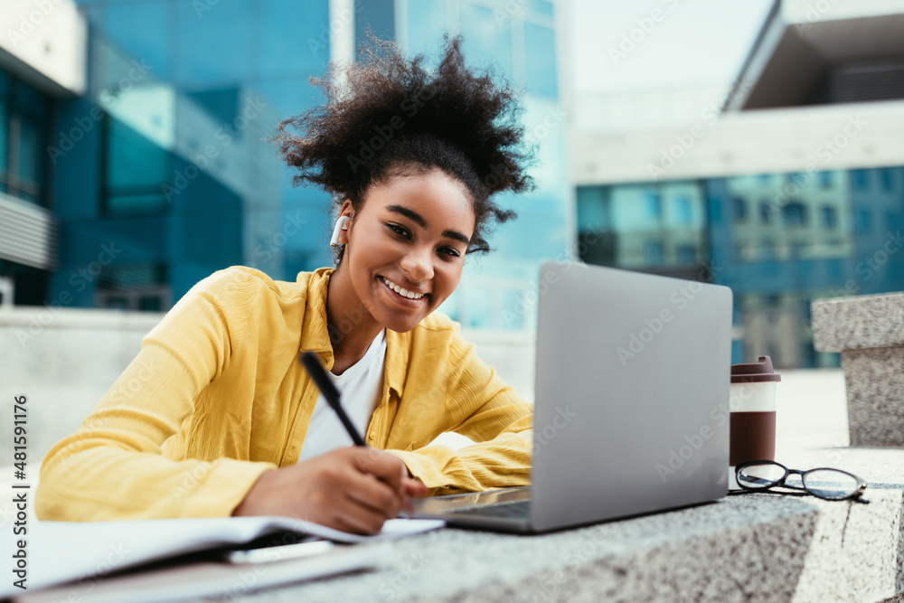 African Student Girl At Laptop Taking Notes Learning Online Outdoors