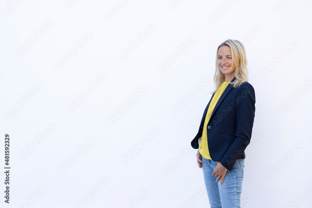 beautiful young woman with blond hair standing in front of white background beautiful young woman with blond hair standing in front of white background