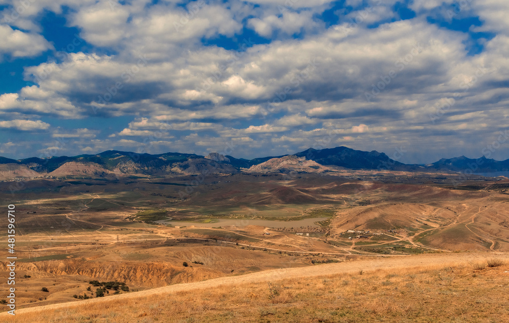 Mountain landscape. View of the mountain hills. Sunny, cloudy day. Mountain landscape. View of the mountain hills. Sunny, cloudy day.