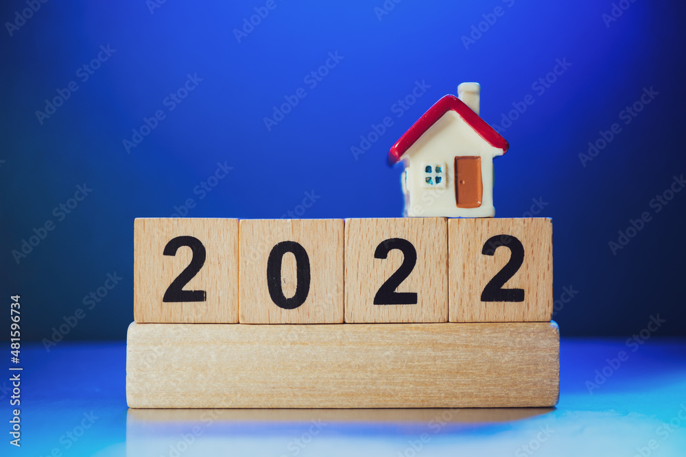 Miniature house on wooden block year 2022 using as family and property real estate concept Miniature house on wooden block year 2022 using as family and property real estate concept