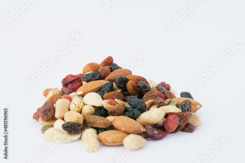 close up of many mixed nuts on white background 