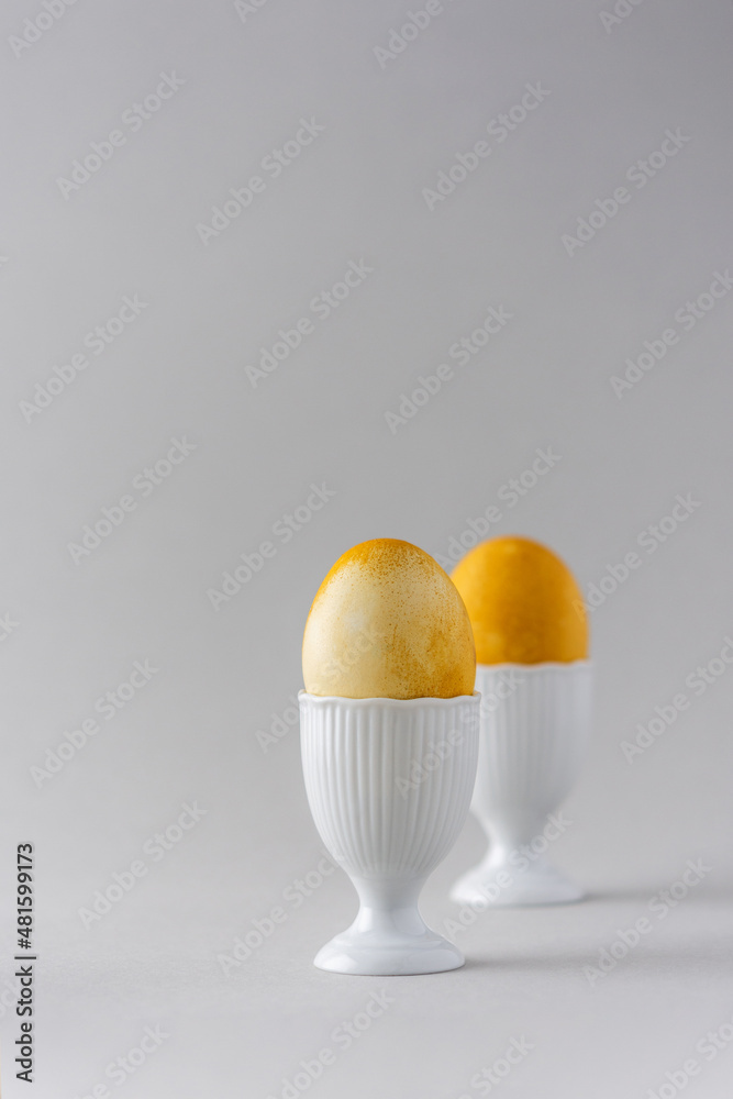 Easter painted yellow eggs in white special forms for eggs on gray background, Easter concept Easter painted yellow eggs in white special forms for eggs on gray background, Easter concept