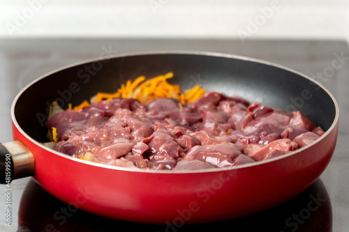 Fried chicken liver with onions and carrots. Selective focus