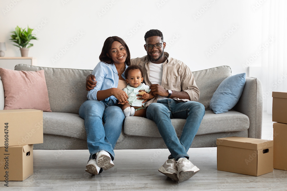 Happy African American family moving in new apartment Happy African American family moving in new apartment