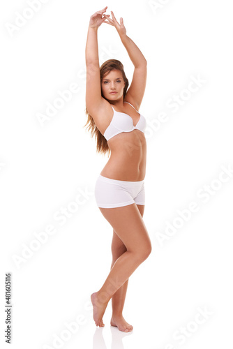 Exuding sexy confidence. Full length studio shot of a curvy young model in underwear isolated on white.