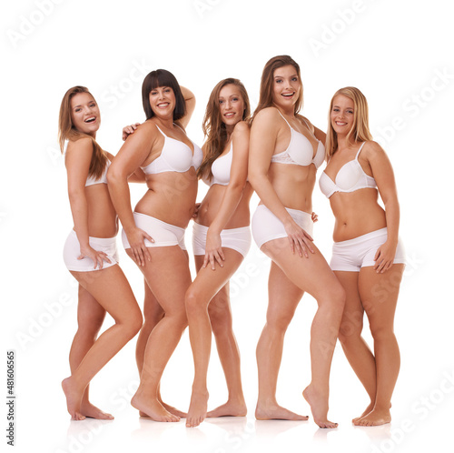 Her confidence is all natural. A group of women with different body shapes standing together in their underwear while isolated on white. © Yuri A/peopleimages.com