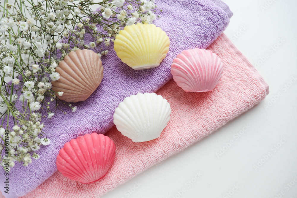 spa theme. a set of towels and colorful handmade soap in the form of a shell