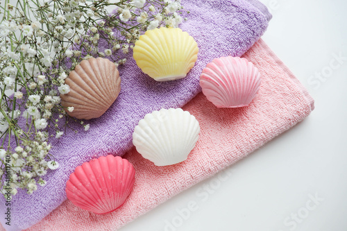 spa theme. a set of towels and colorful handmade soap in the form of a shell