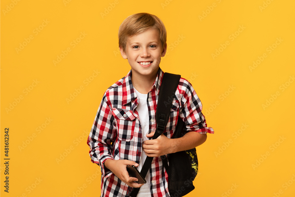 Photo of charming pupil looking at camera. Modern education, knowledge concept, free space Photo of charming pupil looking at camera. Modern education, knowledge concept, free space