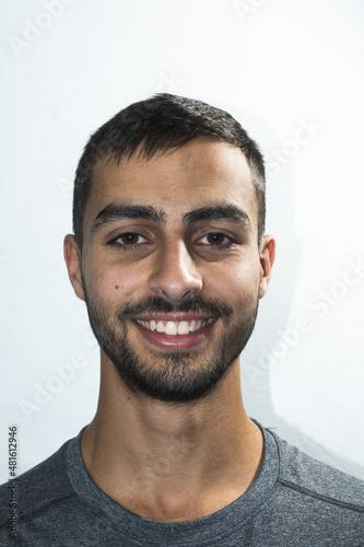 Bearded man smiling on white background