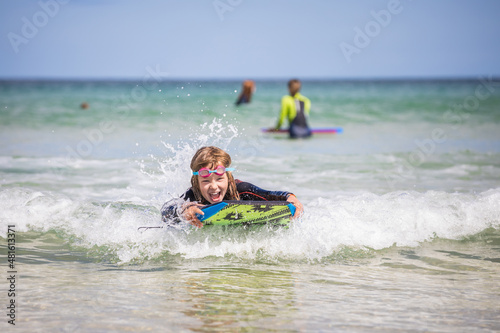 Εκτύπωση καμβά Young girl body boarding on a sunny day.