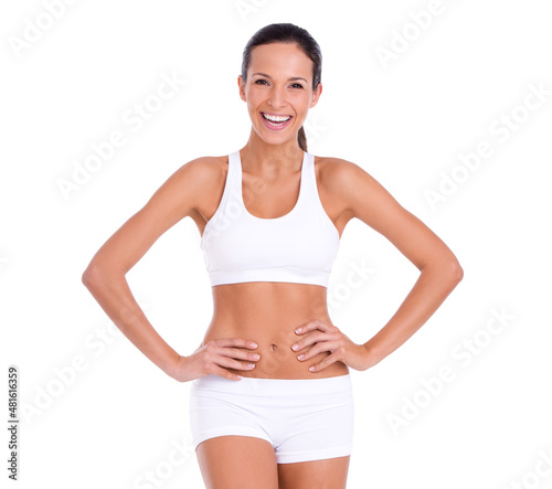 Staying fit isn't always serious. Studio portrait of an attractive woman in exercise clothing isolated on white.