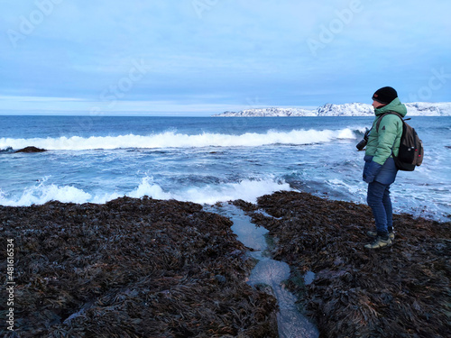 Foto man stands on the shore of a cold sea