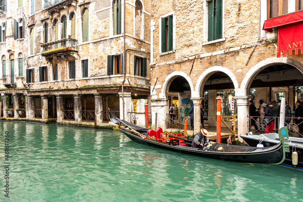 December 2, 2021 - Venice, Italy: Iconic Venice view over the canal with a moored gondola near the old building.