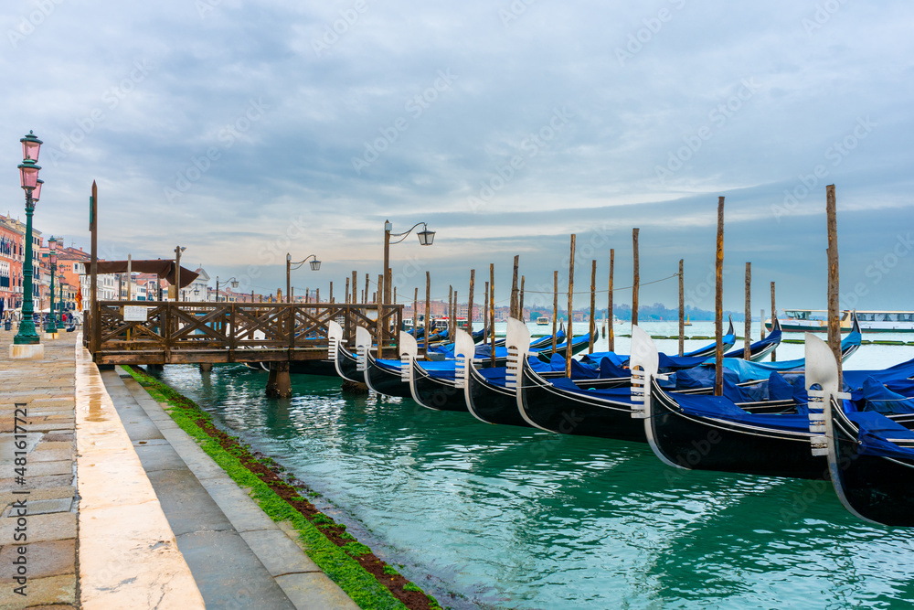 December 2, 2021 - Venice, Italy: Gondolas moored at San Marco Gondola Service Station on Grand Canal.