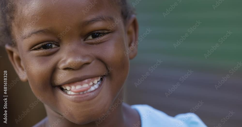 Close-up cute smiling shy portrait Black African township girl