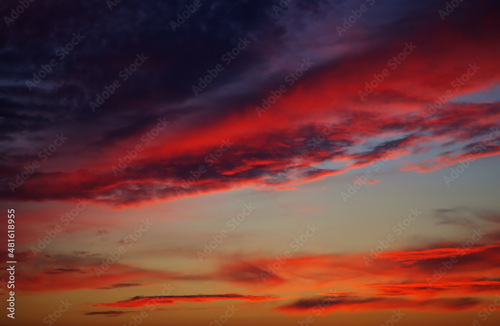 Colorful sunset over the horizont, orange, purple and pink clouds. Gorgeous Panorama twilight sky and cloud at sunset background image. Ideal for advertisement, web and motivation bacgrounds.