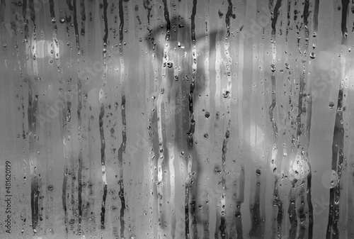 Girl behind wet glass texture. © kishore chandra