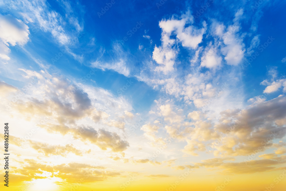 Obraz premium Sky blue and orange light of the sun through the clouds in the sky