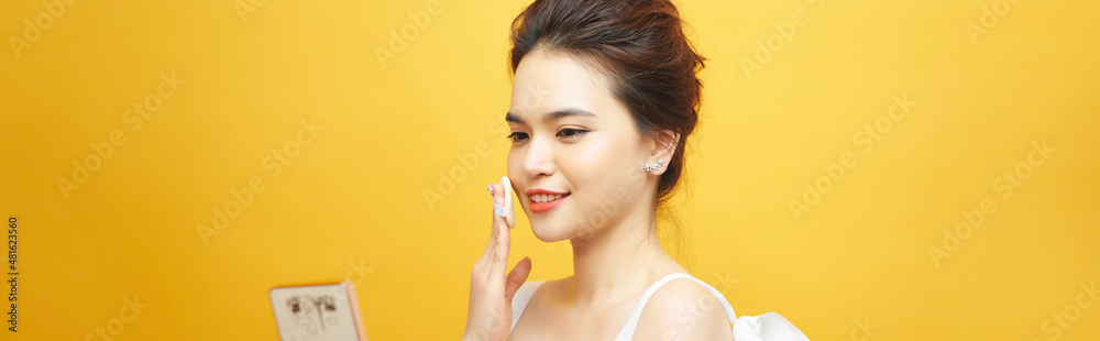 Portrait of asia woman With Cushion Puff And Mirror Applying Makeup Powder Foundation Portrait of asia woman With Cushion Puff And Mirror Applying Makeup Powder Foundation
