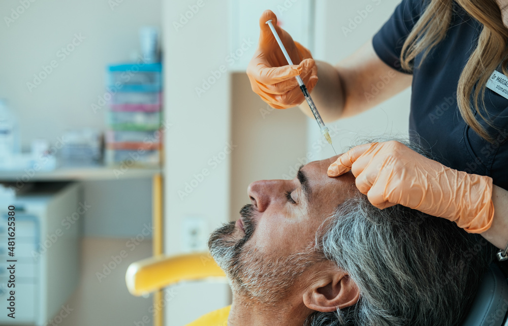 An Anonymous Female Beautician Giving Male Patient Botox Injection In ...