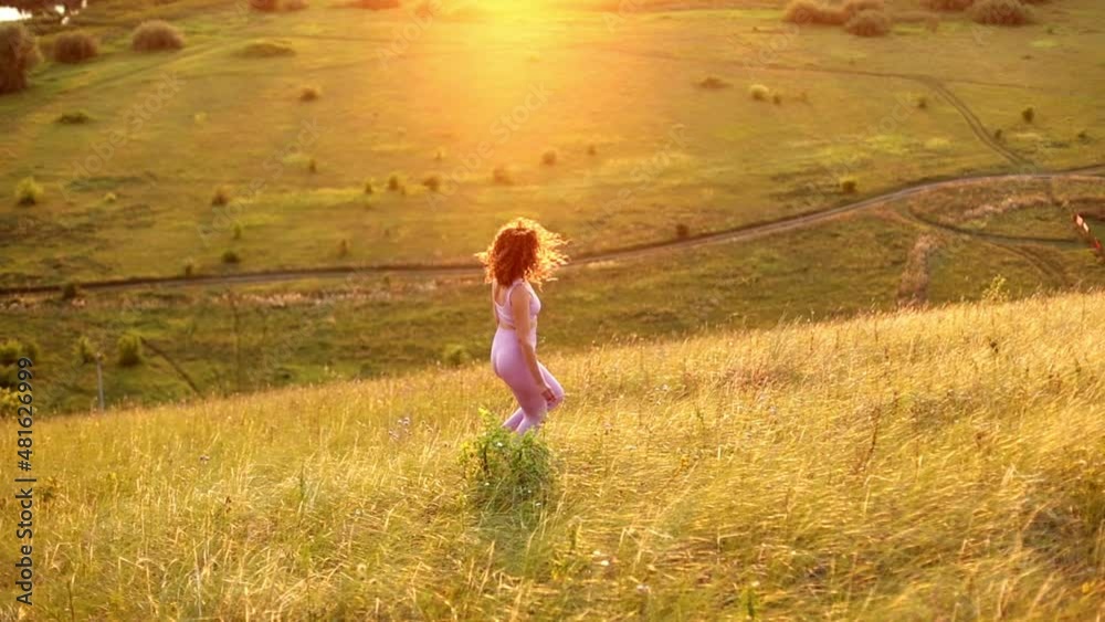 Young woman exercising outdoors against the backdrop of a beautiful sunset, soft focus Young woman exercising outdoors against the backdrop of a beautiful sunset, soft focus