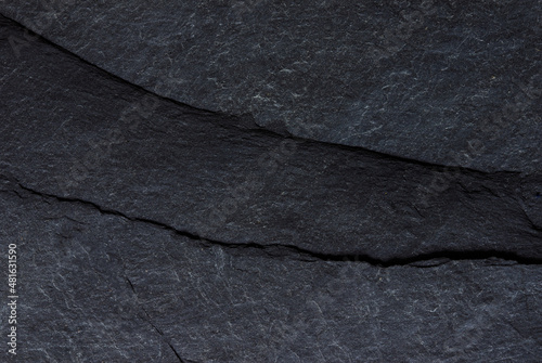 Dark grey black slate background or texture, stone wall surface.