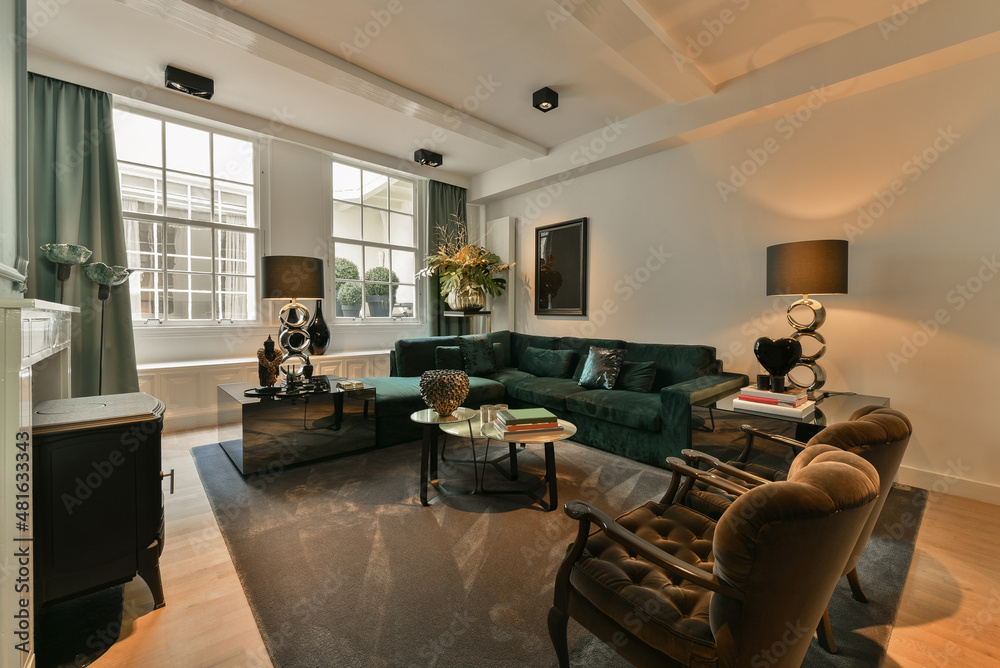 Spacious living room with green sofa and armchairs Spacious living room with green sofa and armchairs