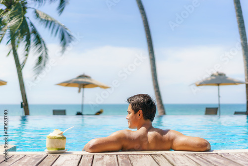 Wallpaper Mural Summer travel vacation concept, Traveler asian man with coconut relax in luxury