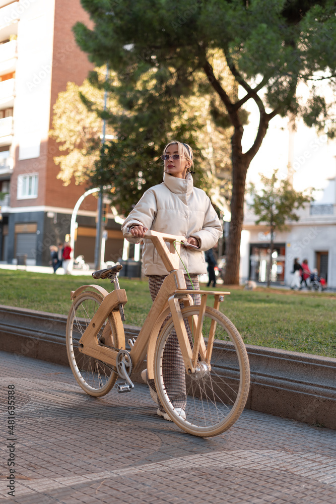 Woman with bicycle walking on pavement