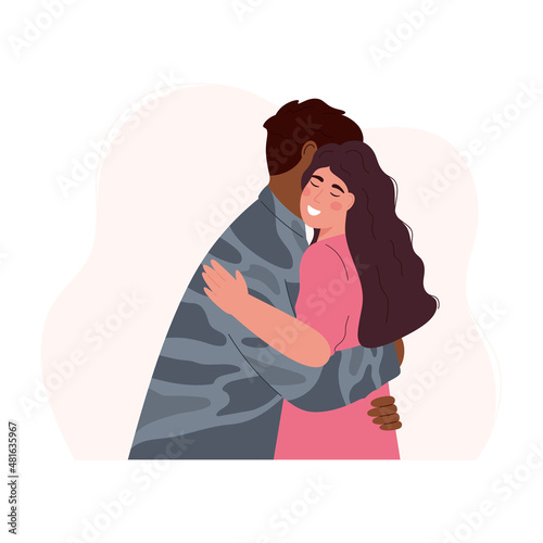 Happy woman embracing soldier after returning home. Military man or soldier dressed in camouflage uniform hugging wife. Long-awaited meeting. Couple reunion.