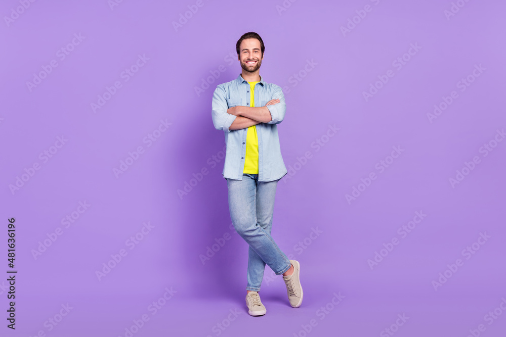 Full size photo of smiling handsome businessman with folded arms wear denim style isolated on purple color background Full size photo of smiling handsome businessman with folded arms wear denim style isolated on purple color background