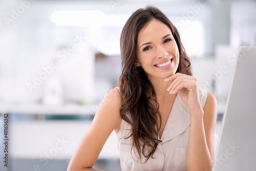 Free Download Business is what I do. Shot of a young attractive woman relaxing at her desk in an office. - GFXLoad