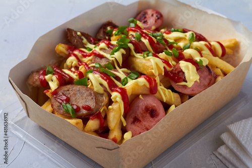 salchipapa, salchipapas traditional street food from Peru with sausages and french fries photo