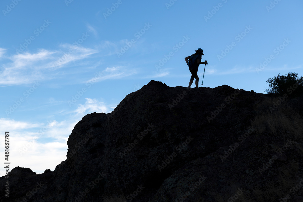 An hiker silhouette on a mountain top