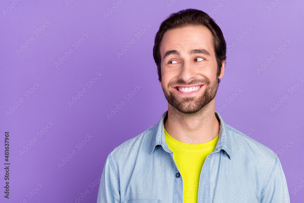 Photo of young cheerful funky male looking copyspace see sale discount advertisement isolated on violet background Photo of young cheerful funky male looking copyspace see sale discount advertisement isolated on violet background