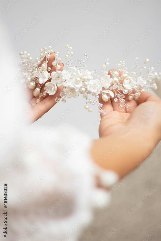 bride hands hold wedding hair accesory with white flowers. jewelry for bride. headpiece for bride. tiara bride hands hold wedding hair accesory with white flowers. jewelry for bride. headpiece for bride. tiara