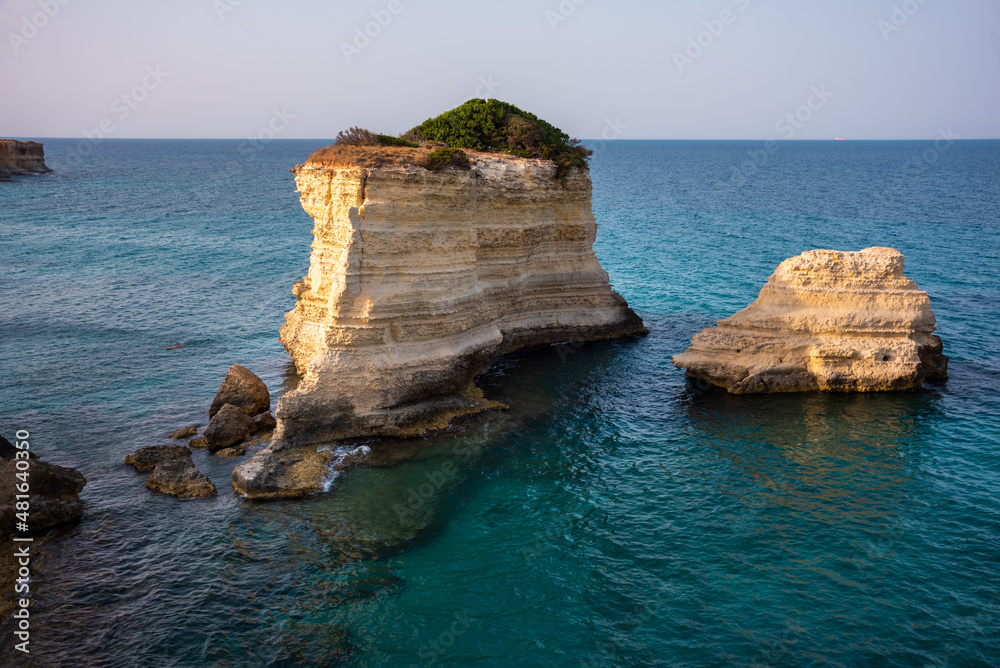 Fototapeta premium Beautiful rocky sea coast in Italy with clear water and stacks