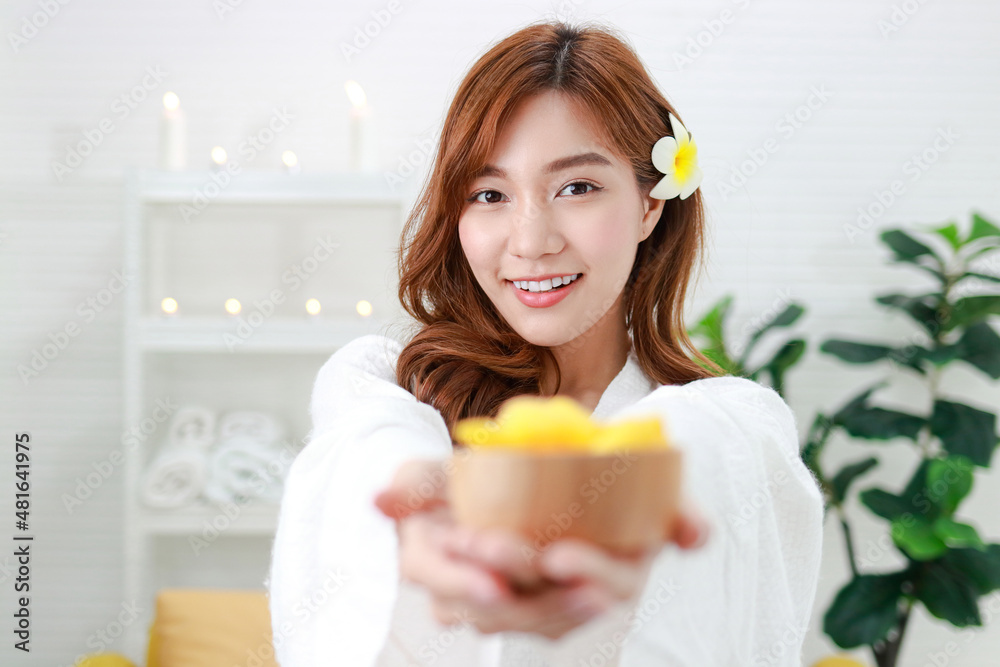 Beautiful Asian woman doing spa at home She holds a golden cocoon that keeps the skin hydrated. Contains whitening agents. Concept of beauty and cosmetics. beautiful health care Beautiful Asian woman doing spa at home She holds a golden cocoon that keeps the skin hydrated. Contains whitening agents. Concept of beauty and cosmetics. beautiful health care