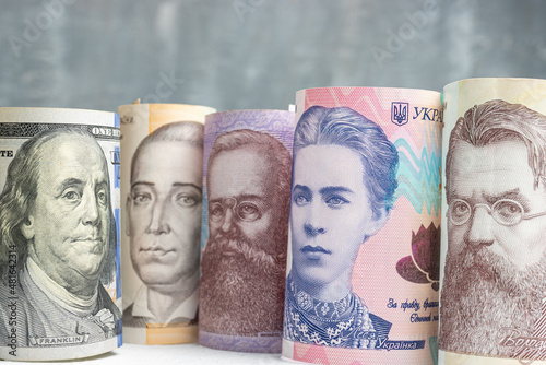Famous ukrainian historical people from banknotes looking to the american president Benjamin Franklin from hundred dollar bill, political and financial allegory photo