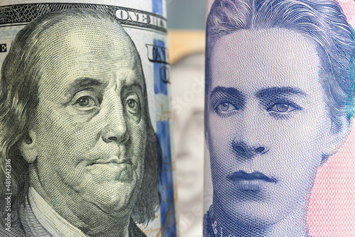 Famous ukrainian poet Lesya Ukrainka from money banknot looking to the american president Benjamin Franklin from dollar bill, political and financial allegory photo