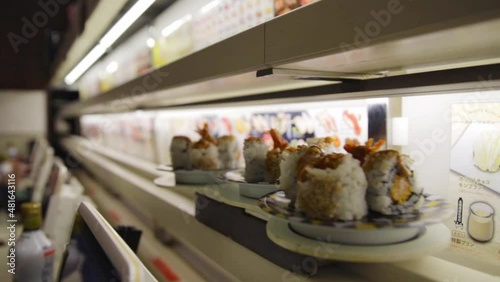 Delivery of sushi via train at a sushi train chain restaurant photo