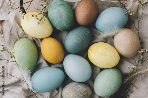 Billede på lærred Easter eggs on rustic linen napkin with tender flowers