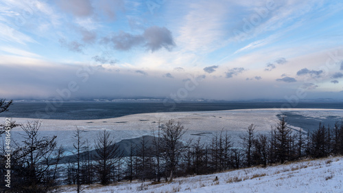 snow on the mountain and frozen lake © Илья Савинков