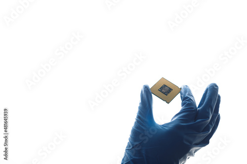 Hand in blue glove holding computer microchip