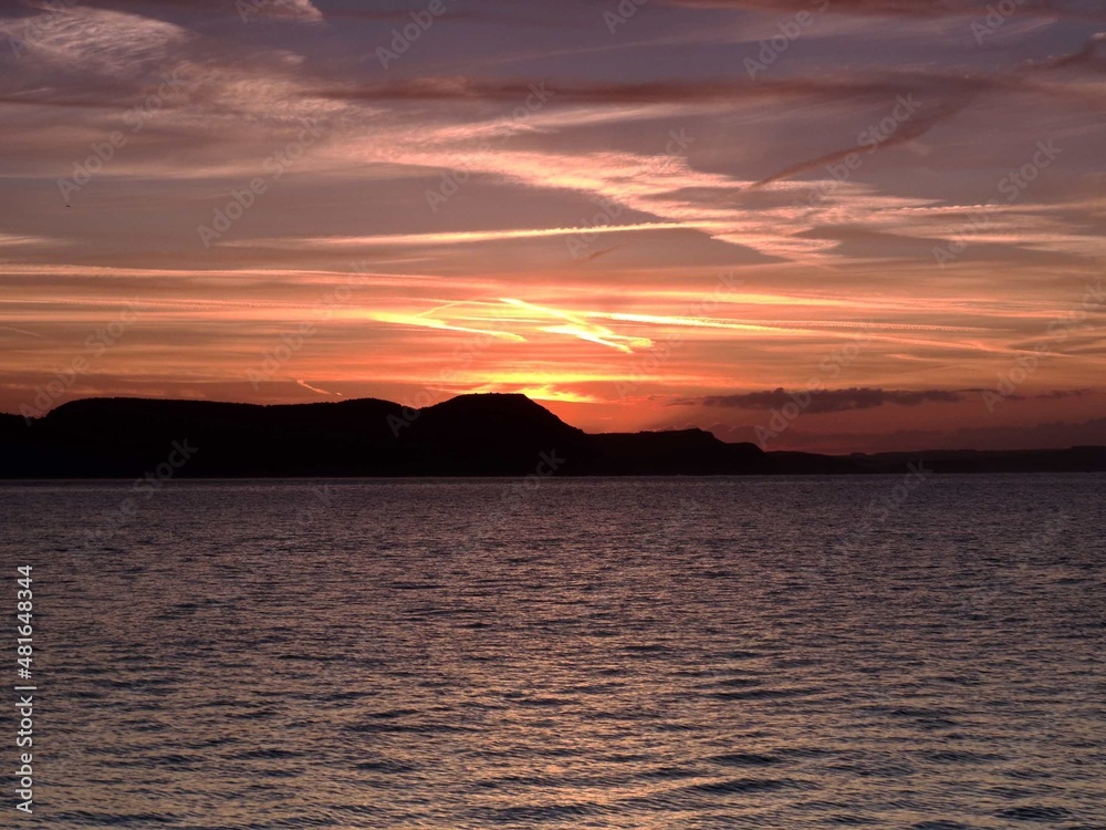 beautiful orange sunrise over the sea and cliffs