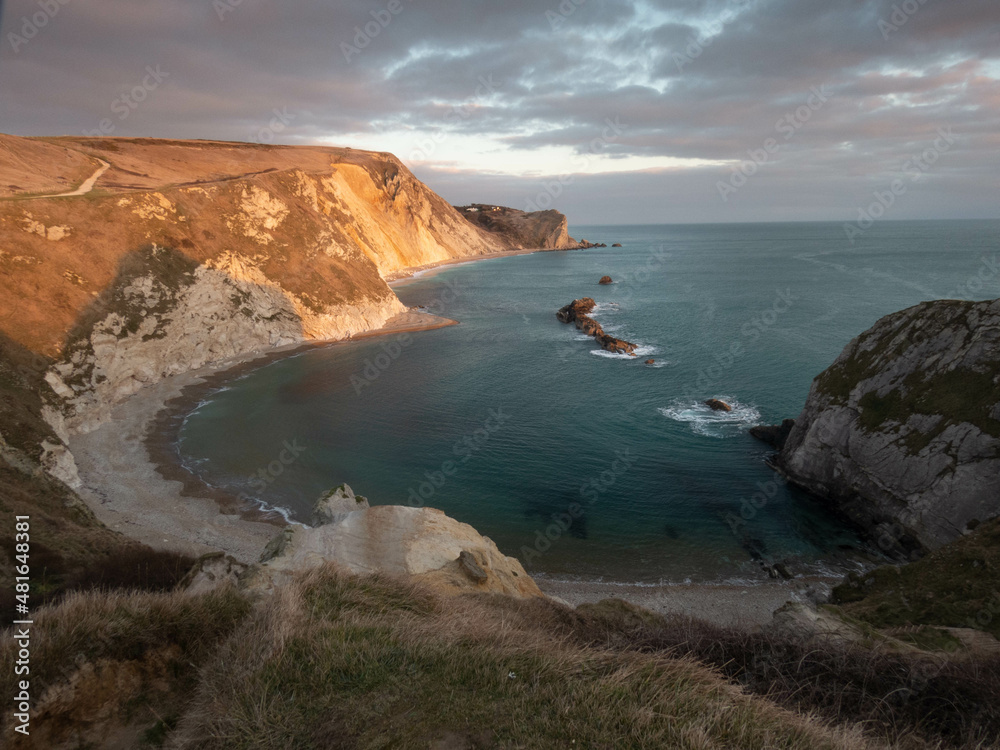 man o war cove Dorset England as the sun starts to go down on a bright winters day