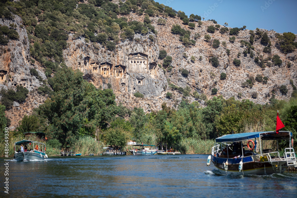 Naklejka premium Rock-cut temple tombs in Kaunos Dalyan - Turkey (Turkish name; kaya mezarlari) Ancient city of Kaunos, Dalyan valley, Turkey. Kaunos (Latin: Caunus) was a city of ancient Caria and in Anatolia