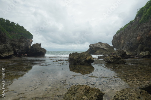 beach with rocks and calm water © Ilham